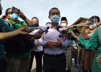 NOOR AZMI Ghazali bercakap kepada pemberita selepas menyantuni keluarga remaja yang yang rebah selepas divaksinasi di Kampung Bukit Duyong, Melaka. - UTUSAN/MUHAMMAD SHAHIZAM TAZALI