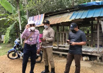MAZLAN Othman (kiri) bersama pegawainya meninjau masalah capaian internet di Kampung Pondok Lama, Pokok Sena, Alor Setar hari ini.  - UTUSAN/NUR ANATI JUHARI