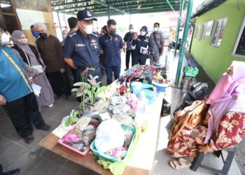 SHAFIEN Mamat (depan) beramah mesra dengan seorang peniaga di Pasar Jelawat, Bachok, hari ini. - ROHANA MOHD. NAWI
