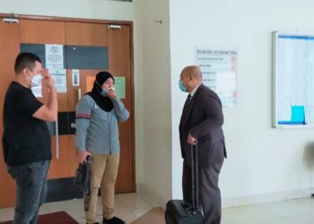 JULIANA Shamsuddin (tengah) berjumpa dengan Khairul Naim (kanan) sebaik sahaja Mahkamah Majistret Klang, Selangor memutuskan melepas dan membebaskan pegawai polis itu daripada pertuduhan menukar barang rampasan.