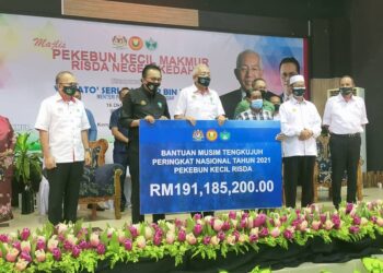 MAHDZIR Khalid (tiga kiri) menyampaikan Bantuan Musim Tengkujuh peringkat Nasional 2021 Pekebun Kecil Risda pada Majlis Pekebun Kecil Makmur Risda Negeri Kedah di  Naka, Padang Terap. - UTUSAN/MOHD.RAFIE AZIMI