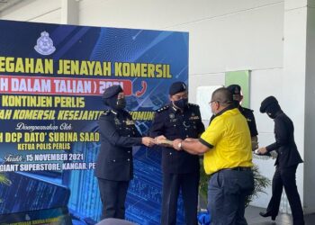 SURINA SAAD (kiri) pada majlis pelancaran Kempen Pencegahan Jenayah Komersial (Jenayah Dalam Talian) 2021 Kontinjen Perlis di Pasar Raya Giant Kangar, Perlis hari ini.- UTUSAN/NAZLINA NADZARI