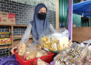 Nuratiqah Ruslan membantu ibunya berniaga nasi kukus dan kerepek di Kinarut, Papar.