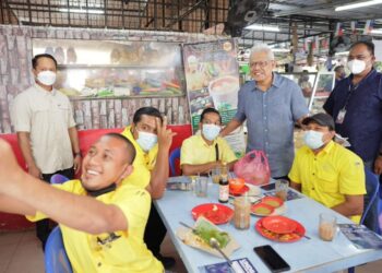 HAMZAH Zainudin (berdiri dua dari kanan) beramah mesra dengan pengunjung ketika bersarapan di sebuah restoran di Melaka.