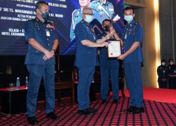 MOHAMMAD Hamdan Wahid (dua dari kiri) menyampaikan Anugerah Khas Pegawai Cemerlang Berterusan Tahun 2020 kepada Sharudi Muhamad Halil pada Majlis Penyampaian Anugerah Perkhidmatan Cemerlang Tahun 2020 JBPM Negeri Perak dan ABPM Wilayah Utara di Ipoh hari ini. - UTUSAN/ZULFACHRI ZULKIFLI.