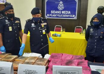 WAN Hassan Wan Ahmad (tengah) menunjukkan ketulan mampat dipercayai dadah jenis ganja yang dirampas di IPD Kulim. - UTUSAN/AZAHAR HASHIM