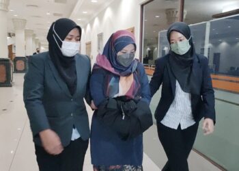 NOR Jihan Musa (tengah) dibawa keluar dari Mahkamah Sesyen Kuantan di Kuantan Pahang oleh pegawai Suruhanjaya Pencegahan Rasuah Malaysia (SPRM) selepas mengaku tidak bersalah atas dakwaan salah guna kuasa. - UTUSAN/DIANA SURYA ABD WAHAB
