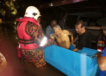ANGGOTA bomba membawa warga emas ke kawasan selamat selepas rumah mereka dinaiki air dalam kejadian banjir kilat di Ipoh. - UTUSAN/IHSAN JBPM PERAK