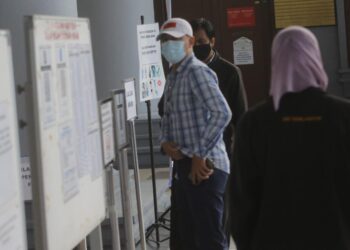 HERISYAM Abdul Wahid (bertopi) hadir di Mahkamah Sesyen Kuala Lumpur bagi menghadapi empat pertuduhan menipu melibatkan penyerahan wang tunai berjumlah RM163,000. - UTUSAN/FAIZ ALIF AHMAD ZUBIR