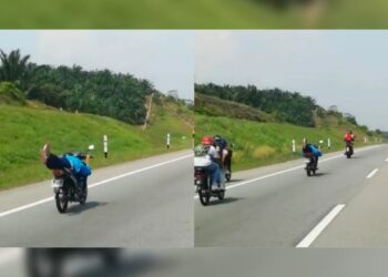 TANGKAP layar video menunjukkan seorang remaja membuat aksi berbahaya ala 'Superman' di Kilometer 24 Lebuh Raya Seremban-Port Dickson.