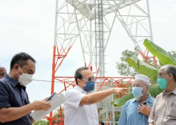 MOHAMMAD FAKHRUDDIN Mohd. Ariff (tengah) melawat menara komunikasi yang dinaiki taraf di Kampung Langgar di Pekan, Pahang.