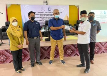 NAZRI Ngah (tiga dari kiri) dan disaksikan oleh Saiful Zaini Mohd. Bokhari (dua dari kiri) menyampaikan bantuan pendidikan kepada wakil Felda Wilayah Jengka sempena program CSR di Felda Sungai Retang di Jerantut, Pahang. - UTUSAN/HARIS FADILAH AHMAD