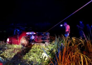 KERETA jenis Honda City yang terbabas dalam tali air di Kampung Bukit Chawi, Kampung Gajah hari ini. - UTUSAN/ZULFACHRI ZULKIFLI
