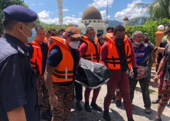 ANGGOTA bomba mengusung mayat Puteh Youp yang ditemukan lemas di Sungai Ketil di Baling hari ini. - UTUSAN/NORLIA RAMLI