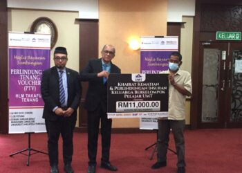 NORDIN Mohamad menerima replika cek daripada Mazlan Abd. Ghaffar (tengah) di Bangunan Canselori, UMT di Kuala Nerus, semalam. - UTUSAN/TENGKU DANISH BAHRI TENGKU YUSOFF