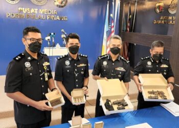 MOHD. SHUHAILY Mohd. Zain (dua dari kanan) menunjukkan senjata api yang dirampas daripada satu kumpulan jenayah terancang dalam sidang akhbar di IPK Pulau Pinang di Georgetown hari ini.