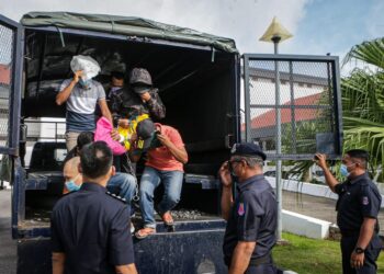 LIMA individu termasuk pegawai dan anggota polis dibawa ke Mahkamah Sesyen atas pertuduhan menyeludup migran pada Mei lalu di Kompleks Mahkamah Alor Setar. - UTUSAN/SHAHIR NOORDIN