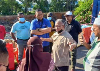 Pengerusi Jawatankuasa Pembangunan dan Keselamatan Kampung (JPKK) Ayer Keroh Heights, Ismail Othman (dua dari kanan) sedang memberi penerangan berhubung kejadian tebing runtuh di Taman Muzaffar Shah, Ayer Keroh, Melaka. - UTUSAN/AMRAN MULUP