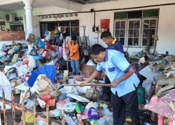 PEKERJA MPT membersihkan sampah sarap dalam kawasan rumah seorang penduduk di Taman Tupai Mas, semalam. - UTUSAN/IHSAN MPT