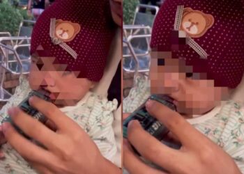TANGKAP layar rakaman video yang tular memaparkan seorang lelaki meletakkan vape pada mulut seorang bayi.