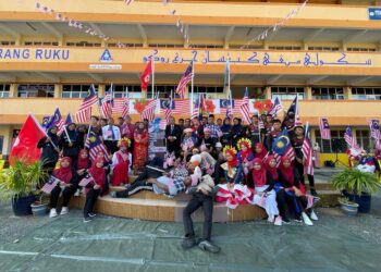 SEBAHAGIAN pelakon sketsa Mat Kilau (terbaring) bersama kepimpinan semasa gimik pelancaran sambutan bulan kemerdekaan negara SMK Cherang Ruku, Pasir Puteh, Kelantan hari ini.-UTUSAN/TOREK SULONG