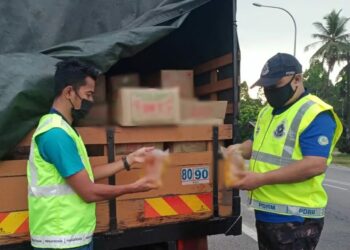 ANGGOTA penguatkuasa KPDNHEP Kelantan (kiri) bersama polis memeriksa minyak masak peket bersubsidi yang dirampas dalam satu serbuan berhampiran kawasan simpangan tiga dekat stesen pemancar televisyen di Peringat, Kota Bharu, Kelantan. - UTUSAN/IHSAN KPDNHEP