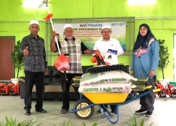 TUAN Mohd. Saripudin Tuan Ismail (dua dari kanan) ketika menyampaikan bantuan input pertanian di Dewan Penggawa Semerak, Pasir Puteh, Kelantan, hari ini.-UTUSAN/TOREK SULONG