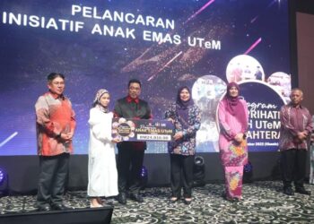 ROHANA Abdullah menerima replika cek program Anak Emas UTeM disampaikan Noraini Ahmad dan Sulaiman Md. Ali  di sebuah hotel di Ayer Keroh, Melaka. - UTUSAN/AMRAN MULUP
