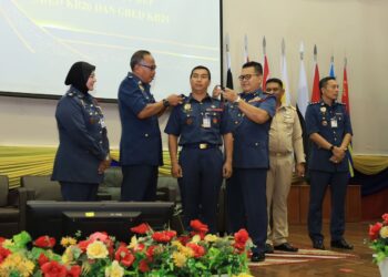 ZAINAL Madasin (kanan) memakaikan tanda pangkat kepada salah seorang pegawai pada Majlis Perhimpunan Bulanan September 2022 di Dewan Utama JBPM Kelantan, hari ini.-UTUSAN/KAMARUL BISMI KAMARUZAMAN