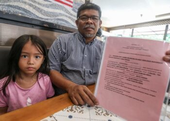 MOHD. FAHMI Ismail, 48, bersama anak angkatnya, Nur Iman Madiha, 6, menunjukkan borang kebenaran bagi pengambilan kanak-kanak Jabatan Kebajikan Masyarakat (JKM) ketika ditemui di Kubang Semang, Pulau Pinang baru-baru ini.