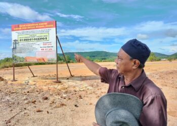 MOHD. Sabri Abd. Kadir menunjukkan papan tanda perancangan pembinaan masjid di Bandar Sri Impian, Kluang, Johor, semalam.