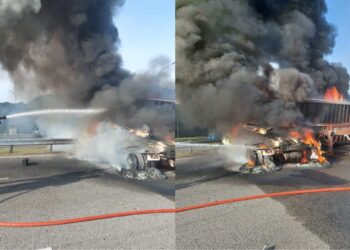 ANGGOTA bomba sedang menjalankan tugas-tugas pemadaman sebuah lori kontena yang terbakar di Kilometer 259.6 (Arah Selatan) berhampiran susur keluar ke Plaza Tol Port Dickson dekat Rasah, Seremban pagi ini. -GAMBAR/IHSAN BOMBA.