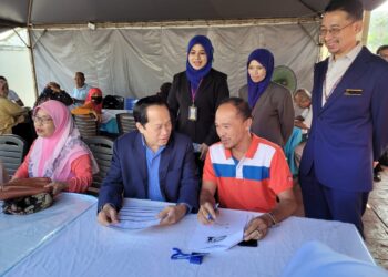 AHMAD Maslan (duduk, tengah) beramah mesra dengan orang ramai yang menjalankan urusan di LHDN Kota Bharu, Kelantan. - UTUSAN/MUSTAQIM MOHAMED