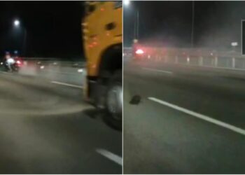 TANGKAP layar video tular memaparkan seorang penunggang motosikal yang hampir dilanggar sebuah treler di Kilometer 276.2 Lebuhraya Utara-Selatan di Nilai, Seremban, kelmarin.