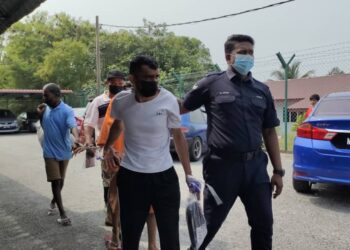 MUHAMMAD Sajid Qamar (dua dari kiri) dibawa ke Mahkamah Majistret Port Dickson bagi didakwa atas tuduhan mencuri di sebuah pasar raya di Lukut, Port Dickson pada 14 April lalu.-UTUSAN/NOR AINNA HAMZAH.