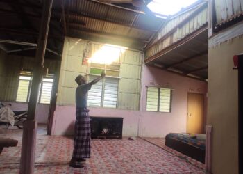 BASIRAN Jamsari menunjukkan bumbung dan atap zink yang rosak akibat ribut di Felda Kota Gelanggi 2 di Jerantut, Pahang.
