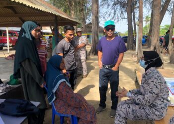 KHAIRUN Dalilah Baharin (kanan) menyantuni keluarga mangsa lemas di Pantai Telong, Bachok, Kelantan, hari ini-UTUSAN/IHSAN MARITIM MALAYSIA KELANTAN