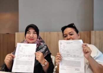 EFFA ( kanan ) dan Ibu Ira ( kiri ) menunjukkan laporan polis yang dibuat di Balai Polis Pontian supaya siasatan dilakukan keatas warganegara Singapura yang melakukan penipuan, di Pontian, disini.