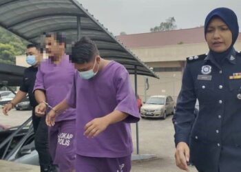 MOHAMAD Izaan Syafiq Anuar (dua dari kanan) dibawa ke Mahkamah Sesyen Kuala Pilah hari ini bagi didakwa atas pertuduhan pecah amanah.-UTUSAN/NOR AINNA HAMZAH.
