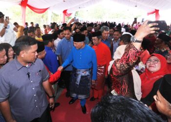 AHMAD Zahid Hamidi beramah mesra dengan orang ramai yang hadir pada Majlis Rumah Terbuka Aidilfitri Badan Perhubungan UMNO Negeri Sembilan di Kompleks Sukan Komuniti Felda Jelai 2, Gemas, Tampin hari ini.-UTUSAN/MOHD. SHAHJEHAN MAAMIN.