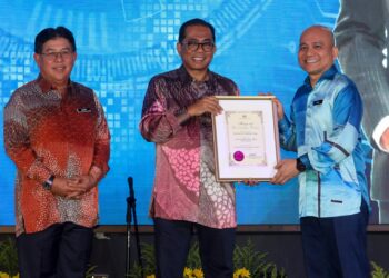 MOHAMED Khaled Nordin menyampaikan Anugerah Kecemerlangan Perdana kepada penerima, Ahmad Rizal Adnan (kanan) pada Majlis Apresiasi Kecemerlangan Kementerian Pendidikan Tinggi Tahun 2022 di Putrajaya. - UTUSAN/FAISOL MUSTAFA