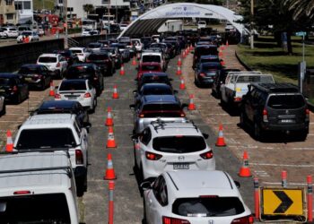 ORANG ramai beratur untuk melakukan ujian Covid-19 secara pandu lalu di Pantai Bondi di Sydney, Australia. - AFP