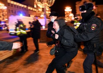 ANGGOTA polis menahan seorang penunjuk perasaan yang membantah peperangan di Ukraine ketika menyertai demonstrasi di Moscow, Rusia. - AFP