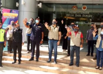 WAN AHMAD FAYHSAL (berdiri tengah, tiga dari kanan) menunjukkan tanda isyarat sokongan kepada peserta konvoi sempena Hari Kesukarelawanan Belia Malaysia 2020 di Putrajaya hari ini. - UTUSAN/AMREE AHMAD