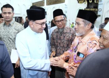 ANWAR Ibrahim bersalam dengan jemaah selepas menunaikan solat Asar di Masjid Sultan Azlan Shah di Ipoh hari ini. - UTUSAN/MUHAMAD NAZREEN SYAH MUSTHAFA