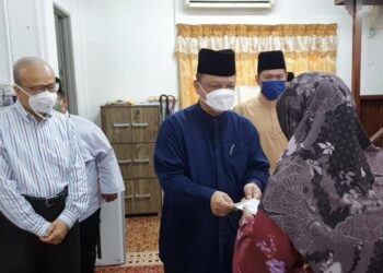 TUANKU Syed Faizuddin Putra Jamalullail menyampaikan sumbangan zakat kepada asnaf di Masjid Nurul Mukminin Alor Ara, Arau, Perlis semalam.-UTUSAN