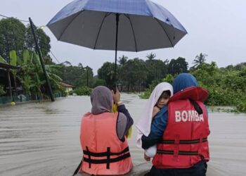 ANGGOTA bomba menyelamatkan mangsa banjir di Kampung Permatang Chicar di Pekan, Pahang. - FOTO IHSAN JBPM PAHANG