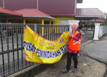 PETUGAS Jawatankuasa Banjir Daerah menurunkan pemidang di sebuah PPS berikutan penutupan dan mangsa banjir pulang ke rumah di Rompin, Pahang. - FOTO /IHSAN JKM ROMPIN