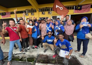 KAMARUDIN Malek (empat dari kanan) berpelukan bersama Azahar Ahmad (lima dari kanan) selepas bertembung sewaktu turun dalam sesi walkabout di Pekan Kuala Perlis, Perlis. UTUSAN/ASYRAF MUHAMMAD.