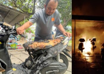 MOHD. AZMIE Azman melihat motosikal miliknya yang musnah dalam kebakaran di Flat B4, Seberang Jaya, Butterworth, Pulau Pinang awal pagi tadi. - Pix: SITI NUR MAS ERAH AMRAN